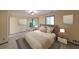 Staged bedroom with queen bed, wood-look floors and two windows at 3038 Skidaway Ct, Stone Mountain, GA 30087