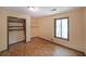 Cozy bedroom with hardwood floors and a built-in closet with shelves at 3038 Skidaway Ct, Stone Mountain, GA 30087