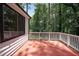 Wide angle exterior shot of deck with wooden railings overlooking wooded backyard at 3038 Skidaway Ct, Stone Mountain, GA 30087