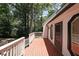 Exterior shot of the deck with wooden railings overlooking wooded backyard at 3038 Skidaway Ct, Stone Mountain, GA 30087