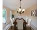 Elegant dining room with table set for six and natural light provided by arched windows at 3038 Skidaway Ct, Stone Mountain, GA 30087