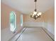 Elegant dining room with natural light provided by arched windows and ceramic floors at 3038 Skidaway Ct, Stone Mountain, GA 30087