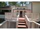 Inviting front deck with railing and steps leading to the front door of this charming two-story home at 3038 Skidaway Ct, Stone Mountain, GA 30087