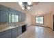 Bright kitchen with a double stainless steel sink, stone backsplash, and tiled flooring at 3038 Skidaway Ct, Stone Mountain, GA 30087