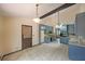 Open kitchen featuring granite countertops, tile flooring, blue cabinets and a center island at 3038 Skidaway Ct, Stone Mountain, GA 30087