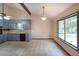 Eat-in kitchen with large window, stainless steel sink, stone backsplash and tiled flooring at 3038 Skidaway Ct, Stone Mountain, GA 30087