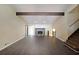 Spacious living room featuring hardwood floors, stone fireplace, high ceilings, and exposed beam at 3038 Skidaway Ct, Stone Mountain, GA 30087