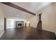 Spacious living room featuring hardwood floors, stone fireplace, high ceilings, and exposed beam at 3038 Skidaway Ct, Stone Mountain, GA 30087
