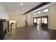Spacious living room featuring hardwood floors, stone fireplace, high ceilings, and exposed beam at 3038 Skidaway Ct, Stone Mountain, GA 30087