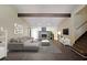 Stylized living room features a stone fireplace, hardwood floors, high ceilings and exposed beam at 3038 Skidaway Ct, Stone Mountain, GA 30087