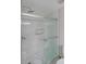 White tiled shower with a glass sliding door and shower head at 3038 Skidaway Ct, Stone Mountain, GA 30087