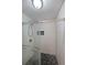 Close-up of tiled shower with a glass door and hexagon-shaped stone floor at 3038 Skidaway Ct, Stone Mountain, GA 30087