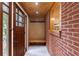 Stylish entryway boasts brick accent wall, integrated bench with storage, and tiled flooring at 44 Aberdeen St, Atlanta, GA 30307