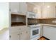 Cozy kitchen features white appliances, ample cabinet space, and wooden floors at 44 Aberdeen St, Atlanta, GA 30307