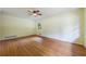 Bright living room with hardwood floors, a ceiling fan, and a large window offering natural light at 44 Aberdeen St, Atlanta, GA 30307