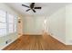 Bright living room featuring hardwood floors, a ceiling fan, and large windows for natural light at 44 Aberdeen St, Atlanta, GA 30307