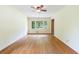Bright living room with hardwood floors, ceiling fan, and large window showcasing the outdoor view at 44 Aberdeen St, Atlanta, GA 30307