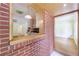View of the kitchen and an adjacent room, accented with brick and wood trim at 44 Aberdeen St, Atlanta, GA 30307
