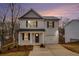 Charming two-story home with gray siding, black shutters, covered entrance, and attached one car garage at 6355 Akins Way, Cumming, GA 30041