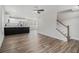 Bright open floor plan featuring vinyl floors, ceiling fan, and a modern kitchen with stainless steel appliances at 6355 Akins Way, Cumming, GA 30041