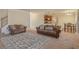Open-concept living room with hardwood floors, stylish sofas, and a dining area at 7347 Moss Stone Dr, Conyers, GA 30094