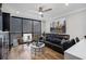 Stylish living room featuring a modern ceiling fan, zebra pillows, and hardwood floors at 1280 W Peachtree W St, Atlanta, GA 30309