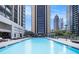 Rooftop pool with skyline views and lounge seating for residents at 1280 W Peachtree W St, Atlanta, GA 30309