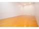 Spacious racquetball court with hardwood floors and blank white walls at 1280 W Peachtree W St, Atlanta, GA 30309