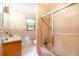 Bathroom featuring a shower-tub combo, light-colored tiling, and a traditional vanity at 5670 Lanny Dr, Powder Springs, GA 30127