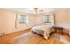 Bedroom features hardwood floors, neutral paint and ample natural light at 5670 Lanny Dr, Powder Springs, GA 30127