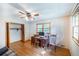 This bedroom features a ceiling fan, hardwood floors, closet, and a desk with computer at 5670 Lanny Dr, Powder Springs, GA 30127