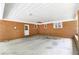 Brick carport featuring an outdoor ceiling, white door, and open parking space at 5670 Lanny Dr, Powder Springs, GA 30127