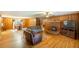 Open living room with wood paneling, hardwood floors and view to dining area at 5670 Lanny Dr, Powder Springs, GA 30127