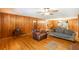 Living room showcasing hardwood floors, wood paneling and large windows at 5670 Lanny Dr, Powder Springs, GA 30127