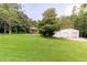 Wide shot of a large yard with a house and outbuilding at 5670 Lanny Dr, Powder Springs, GA 30127
