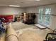 This unfinished basement has concrete flooring, storage, and a door to the exterior at 1005 Timbervale Ln, Lithonia, GA 30058