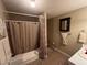 This bathroom features a tub/shower combo with decorative shower curtains and vanity space at 1005 Timbervale Ln, Lithonia, GA 30058