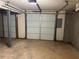 This unfinished garage has concrete flooring and white garage doors at 1005 Timbervale Ln, Lithonia, GA 30058
