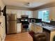 Well-equipped kitchen with stainless steel appliances, white cabinetry, and granite countertops at 1005 Timbervale Ln, Lithonia, GA 30058