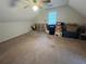 This empty room features carpet flooring, a window, and neutral paint at 1005 Timbervale Ln, Lithonia, GA 30058
