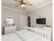 Cozy bedroom with white furniture, carpet flooring, and a ceiling fan at 5507 Aviemore Ct, Suwanee, GA 30024