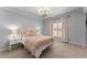 Comfortable bedroom with neutral decor, including a plush bed, side tables, and natural light at 5507 Aviemore Ct, Suwanee, GA 30024