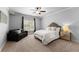 Bright bedroom featuring a queen bed, sofa, and a view of the window at 5507 Aviemore Ct, Suwanee, GA 30024