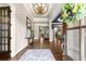 Inviting foyer with hardwood floors, a chandelier, and a view into the home at 5507 Aviemore Ct, Suwanee, GA 30024