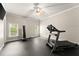 Bright and spacious gym includes a treadmill, punching bag, and large windows for a motivating workout space at 5507 Aviemore Ct, Suwanee, GA 30024