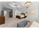 Spacious main bedroom features a decorative tray ceiling, chandelier, sitting area, and luxury touches at 5507 Aviemore Ct, Suwanee, GA 30024