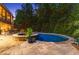 Inviting in-ground pool and spa are surrounded by lush landscaping and stone patio at 5507 Aviemore Ct, Suwanee, GA 30024