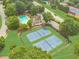 Scenic aerial view of community pool, tennis courts, and clubhouse surrounded by lush landscaping at 1432 Arbor Bluff Ct, Lawrenceville, GA 30045