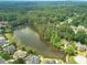 Aerial view of a large lake, surrounded by dense trees, near a neighborhood of beautiful homes at 1432 Arbor Bluff Ct, Lawrenceville, GA 30045