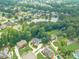 Aerial view of neighborhood, showcasing the homes, pond, and surrounding green spaces at 1432 Arbor Bluff Ct, Lawrenceville, GA 30045